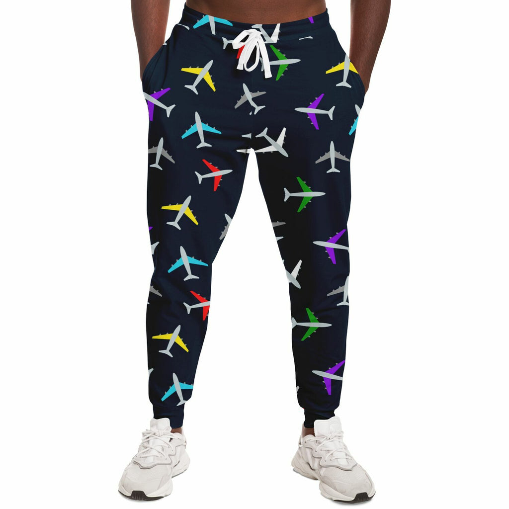 Front view of a man wearing airplane-patterned joggers with a colorful aviation theme, highlighting the elastic waistband and stylish design.